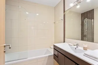 a bathroom with a white tub and a sink and a bath tubermott at Vale San Antonio Apartments in Almancil