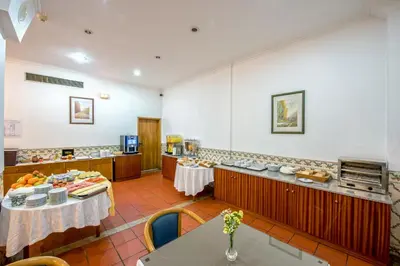 a restaurant with two tables and a buffet at Colina do Mar in Albufeira