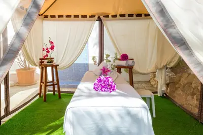 a tent with a table and flowers on it at Janelas do Mar Apartamentos Turisticos in Albufeira