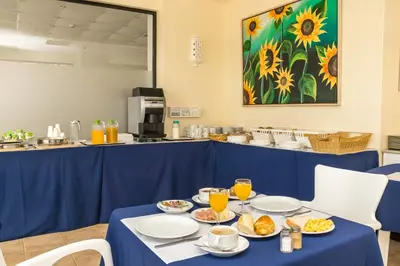 a blue table with plates of food on it at Janelas do Mar Apartamentos Turisticos in Albufeira