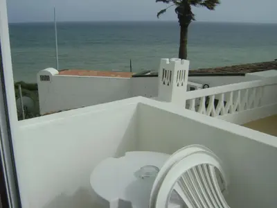 a white toilet on a balcony overlooking the ocean at Frentomar in Albufeira