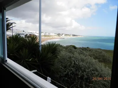 a view of a beach from a window at Frentomar in Albufeira