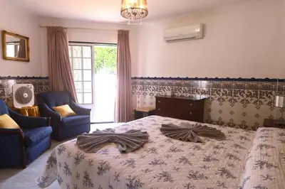 a bedroom with two pink beds and a mirror at Quinta Das Flores, Lote 9 in Albufeira