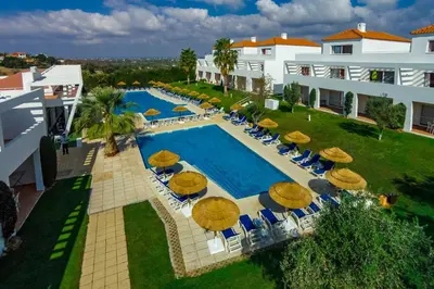 an overhead view of a swimming pool with umbrellas and chairs at Pateo Village in Albufeira