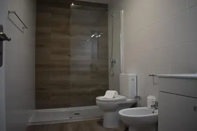 a bathroom with a shower and a toilet and a sink at Club Ouratlantico in Albufeira