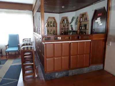 a bar with a ladder and some bottles of wine at Hotel Mar A Vista in Albufeira