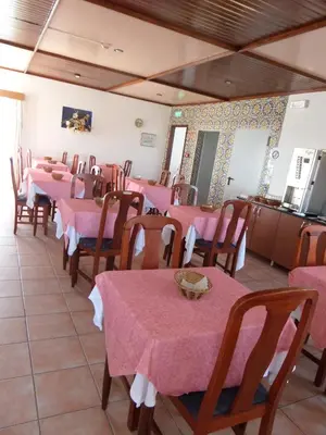 a dining room with pink tables and chairs at Hotel Mar A Vista in Albufeira