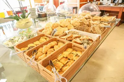 a buffet of pastries in wooden boxes on a table at Boa Vista Hotel & Spa - Adults Only in Albufeira