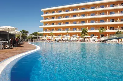 a hotel with a swimming pool in front of a hotel at Hotel Apartamento Balaia Atlantico in Albufeira