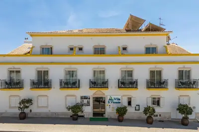 a view of a beach with umbrellas and the ocean at Vila Sao Vicente Boutique (Adults Only) in Albufeira