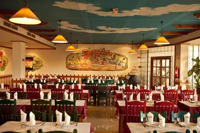 a dining room with red tables and chairs at Hospedaria Frangaria in Faro