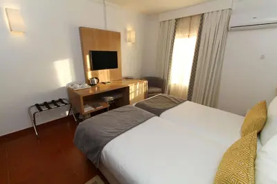 a hotel room with a bed and a desk at Best Western Hotel Dom Bernardo in Faro