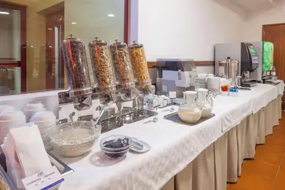 a long white table with food items on it at Best Western Hotel Dom Bernardo in Faro