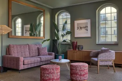 a living room with a purple couch and two chairs at Domes Lake Algarve, Autograph Collection in Vilamoura