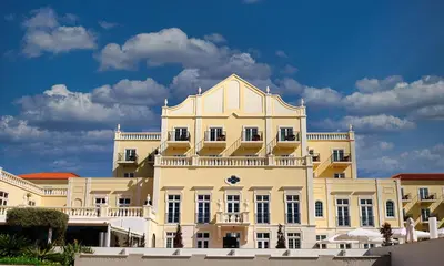 a white building with a balcony on top of it at Domes Lake Algarve, Autograph Collection in Vilamoura