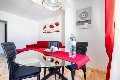 a dining room with a glass table and black chairs at My Place @ Faro City Views in Faro