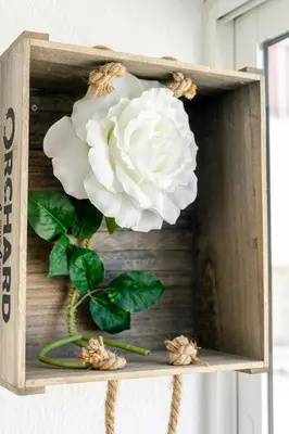 a white rose in a wooden box with a flower at My Place @ Faro City Views in Faro