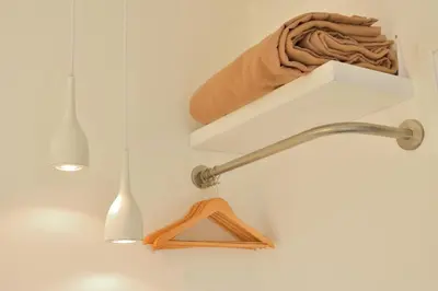 a kitchen sink with a faucet and a shelf at Hotel Sol Algarve by Kavia in Faro