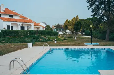 a swimming pool in front of a house at Apartamentos Vale de Carros by Umbral in Albufeira