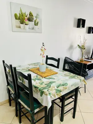a dining room table with chairs and a table cloth at Seashell Apartment OURA in Albufeira