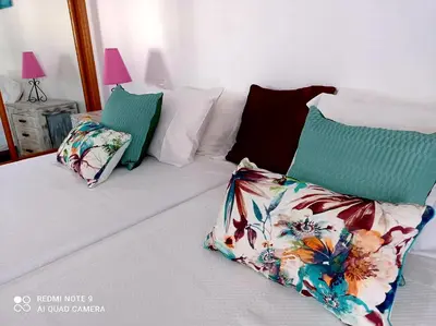 a bed with two pillows at Seashell Apartment OURA in Albufeira