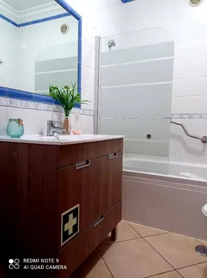 a bathroom with a sink and a bath tub at Seashell Apartment OURA in Albufeira