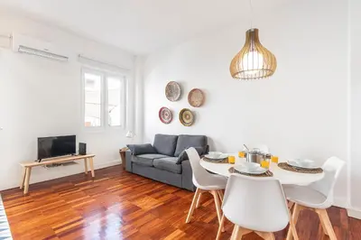 a living room with a couch and a table at RG Downtown Duplex in Faro