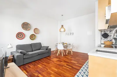 a living room with a couch and a table at RG Downtown Duplex in Faro