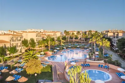 an aerial view of a resort with a pool and palm trees at 3HB Clube Humbria - All Inclusive in Albufeira