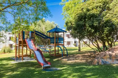 a playground with a slide in a park at Clube Albufeira Garden Village in Albufeira