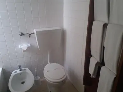 a small bathroom with a toilet and a bidet at Aldeia Da Falesia in Albufeira