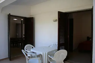 a white table and white chairs in a room at Aldeia Da Falesia in Albufeira