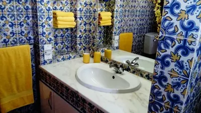 a bathroom with a sink and yellow towels at 60m2 Lovely traditional apartment in Clube Albufeira in Albufeira