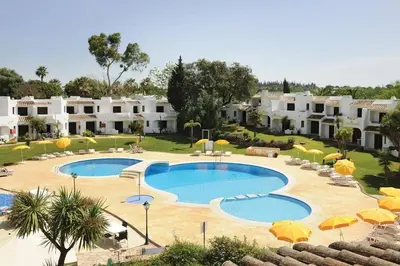 a resort with two pools and umbrellas and buildings at 60m2 Lovely traditional apartment in Clube Albufeira in Albufeira