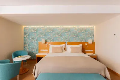 a building with a courtyard with tables and chairs at Falésia Hotel - Adults Only in Albufeira