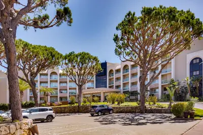a large living room with couches and a piano at Falésia Hotel - Adults Only in Albufeira