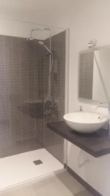 a bathroom with a sink and a shower with a tub at Orange Studio in Vilamoura