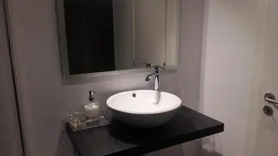 a bathroom with a white sink and a mirror at Orange Studio in Vilamoura