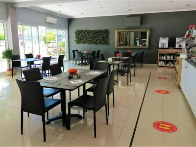 a dining room with tables and chairs in a restaurant at The Navigator - Olympus Marina in Vilamoura