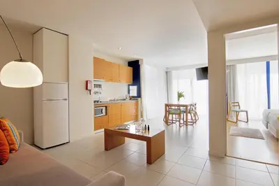 a kitchen and living room with a couch and a table at The Navigator - Olympus Marina in Vilamoura