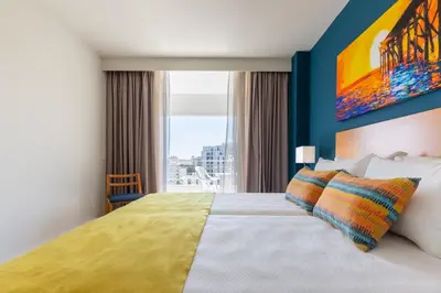 a bedroom with a large bed with a large window at The Navigator - Olympus Marina in Vilamoura