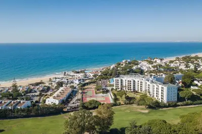 an aerial view of a resort and the beach at Dona Filipa Hotel in Vale do Lobo