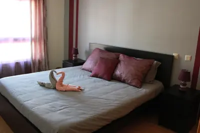 a stuffed animal is sitting on a bed at Sweet Dream House in Faro