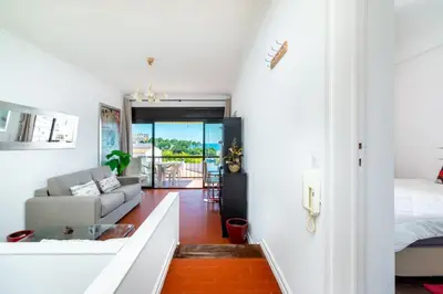 a room with a bed and a living room with a couch at WHome | Albufeira Suite & Beach Apartment in Albufeira