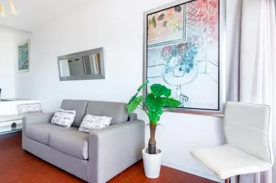 a living room with a couch and a chair at WHome | Albufeira Suite & Beach Apartment in Albufeira