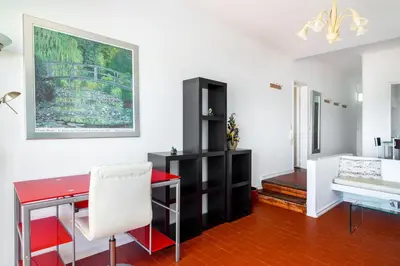a living room with a red desk and a couch at WHome | Albufeira Suite & Beach Apartment in Albufeira