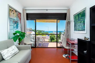 a living room with a couch and a table at WHome | Albufeira Suite & Beach Apartment in Albufeira