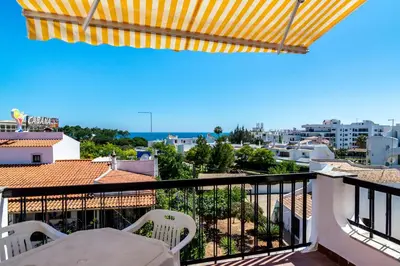 a balcony with chairs and a view of the city at WHome | Albufeira Suite & Beach Apartment in Albufeira