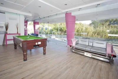 a room with a pool table and two chairs at Bayside Salgados in Albufeira
