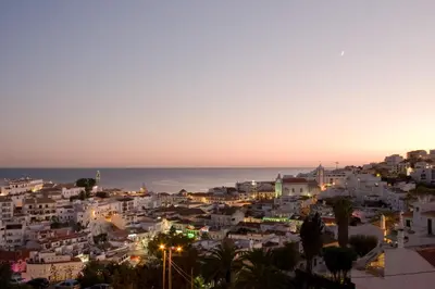 a bedroom with a bed with a view of the ocean at Cerro Mar Atlantico & Cerro Mar Garden in Albufeira